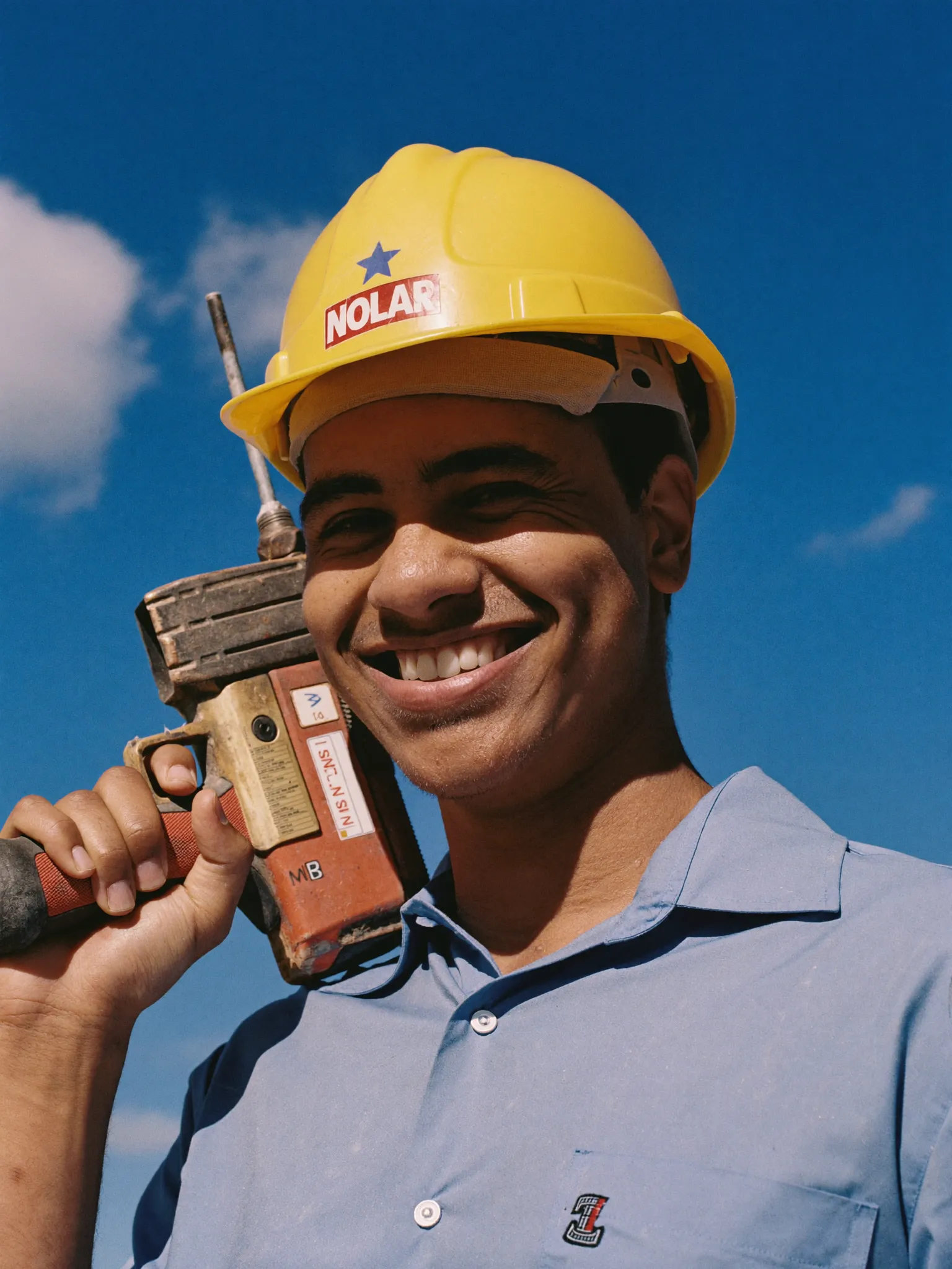 Leo, installer, grinning with a nail gun