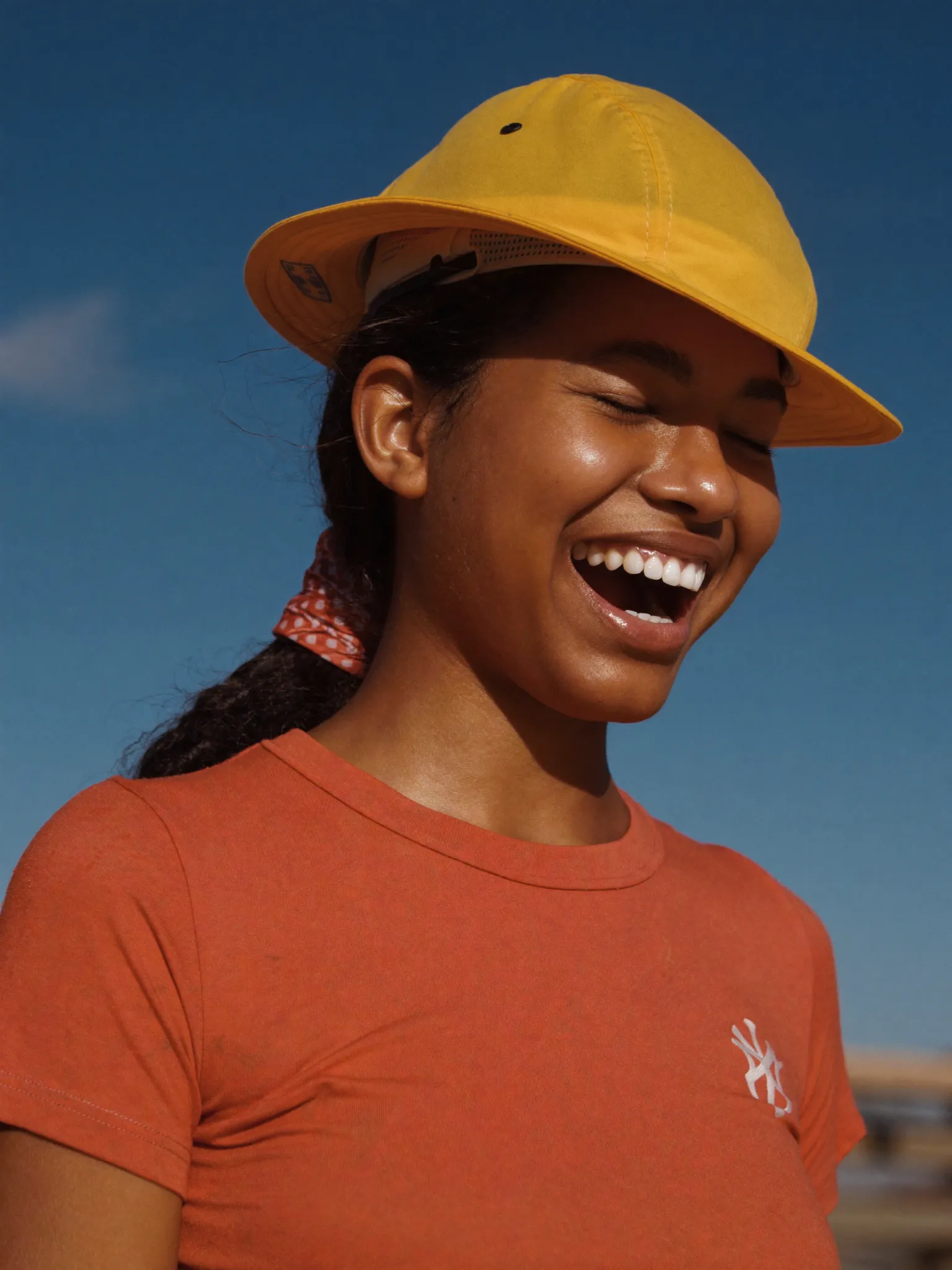 Maya, estimator, smiling in a yellow hard hat